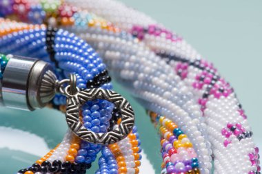 Odaklanamayan özel bir fotoğraf. El yapımı kolye tokası. Moda boncuk deseni. Hobi ve nakış işi.