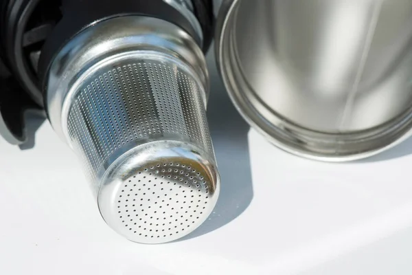 Stainless steel tea strainer infuser close up. Tool for thermos or coffee mug with spill proof lid. Mockup.