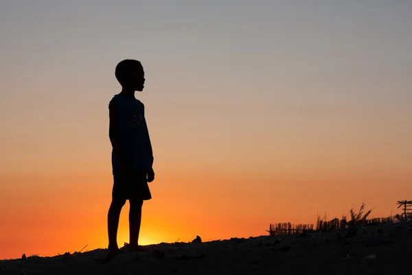 Junge am Strand bei Sonnenuntergang — Stockfoto