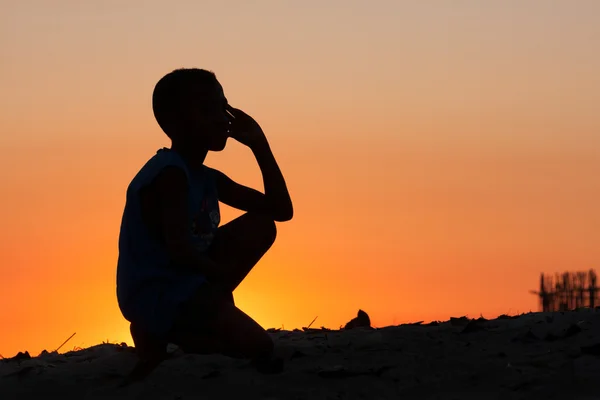 Boy on the beach on sunset — Stock Photo, Image