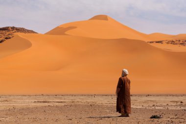 Muslim praying in the desert clipart