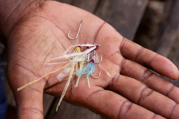 Homemade fishing hooks on the man's palm — Stock Photo, Image