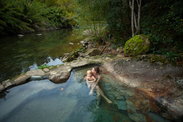 Mother and child are swimming in a thermic pool — Stock Photo, Image