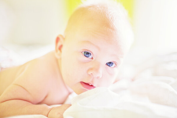 Baby girl under the white blanket