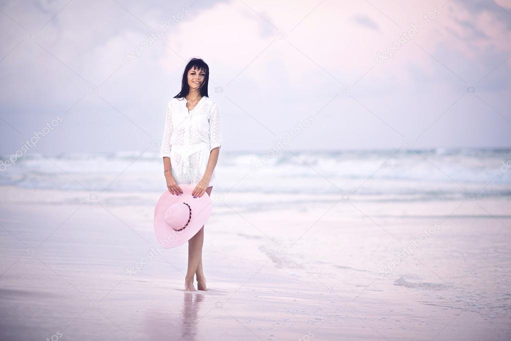 Woman at the beach on sunset