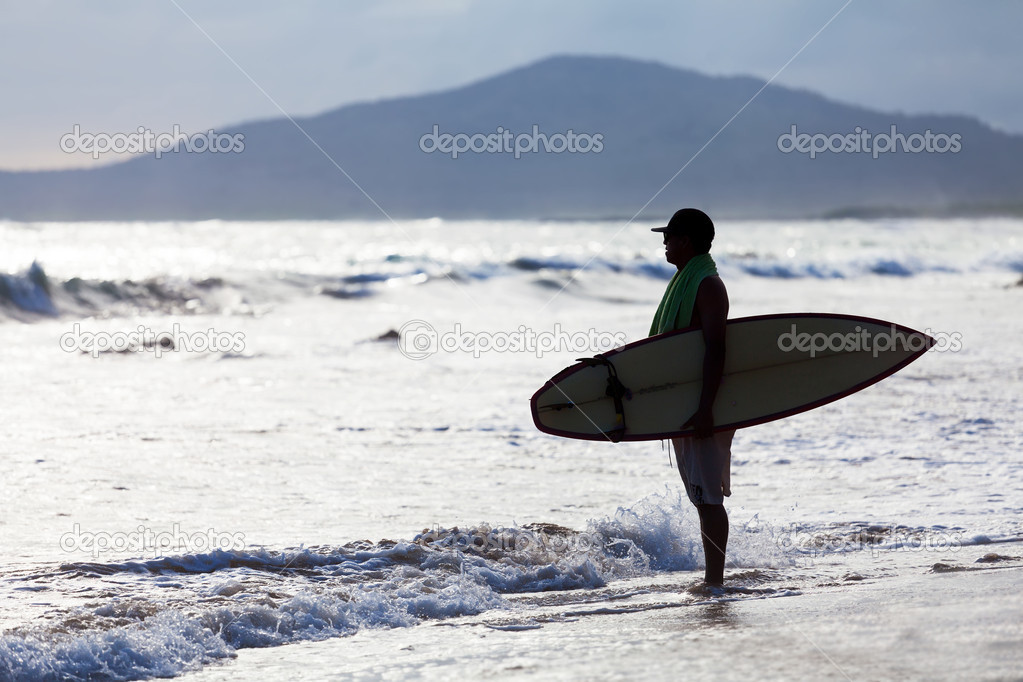 Surfer on the ocean beach, Galapagos islands, Equador
