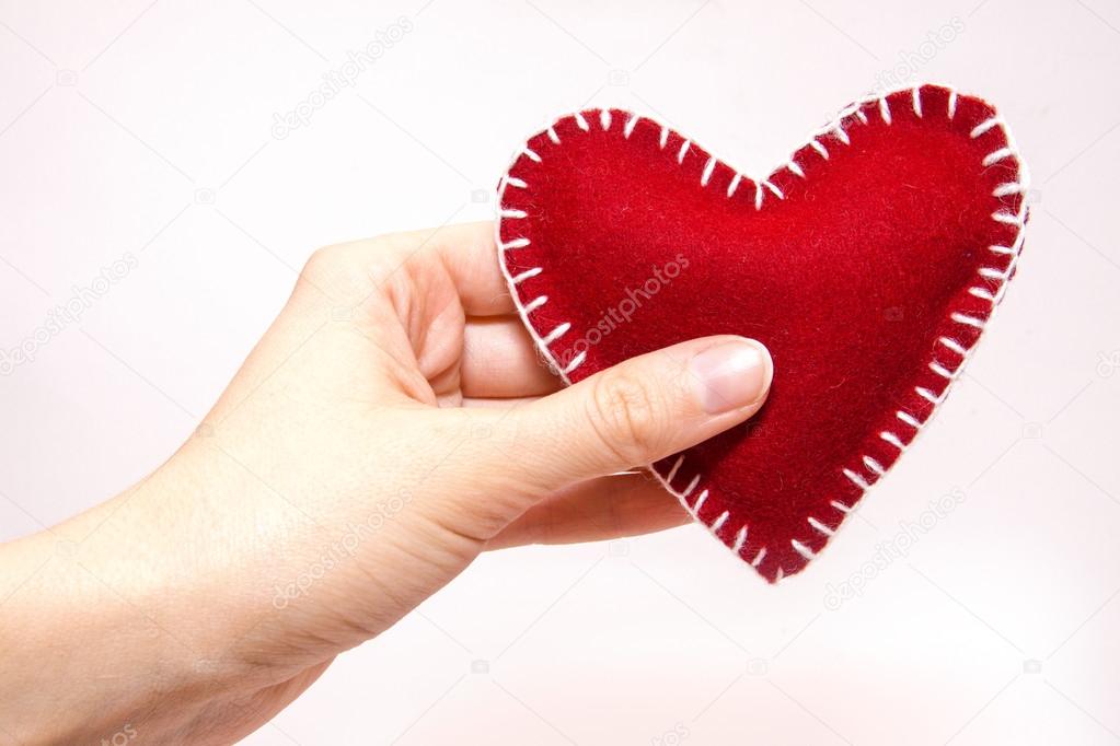 Red heart in hand