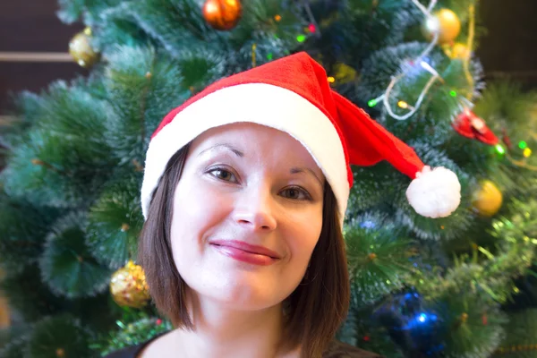 Woman in Christmas hat Stock Picture