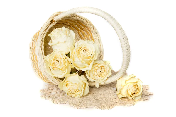 Dried roses in basket with doily — Stock Photo, Image