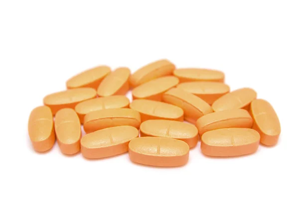 Куча апельсиновых таблеток — стоковое фото