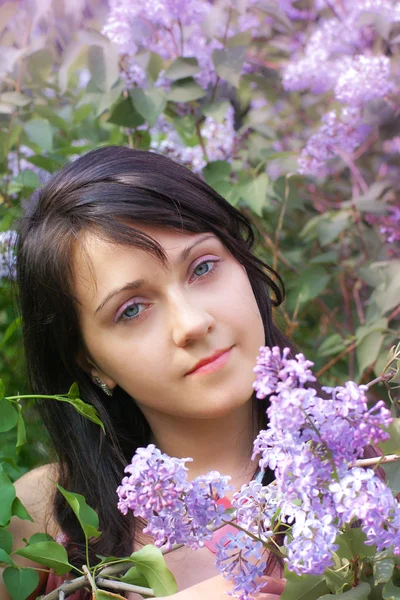 Woman and lilac flowers — Stock Photo, Image