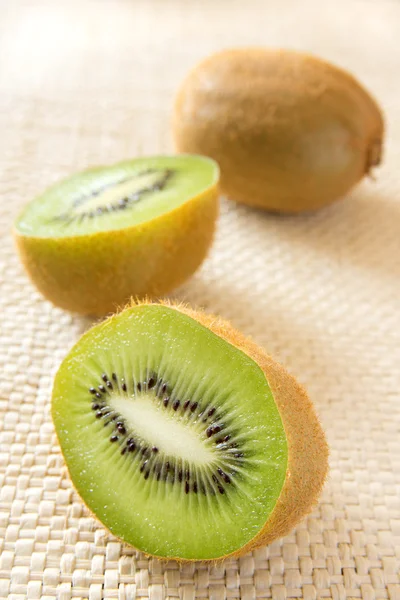 Kiwi on straw background — Stock Photo, Image