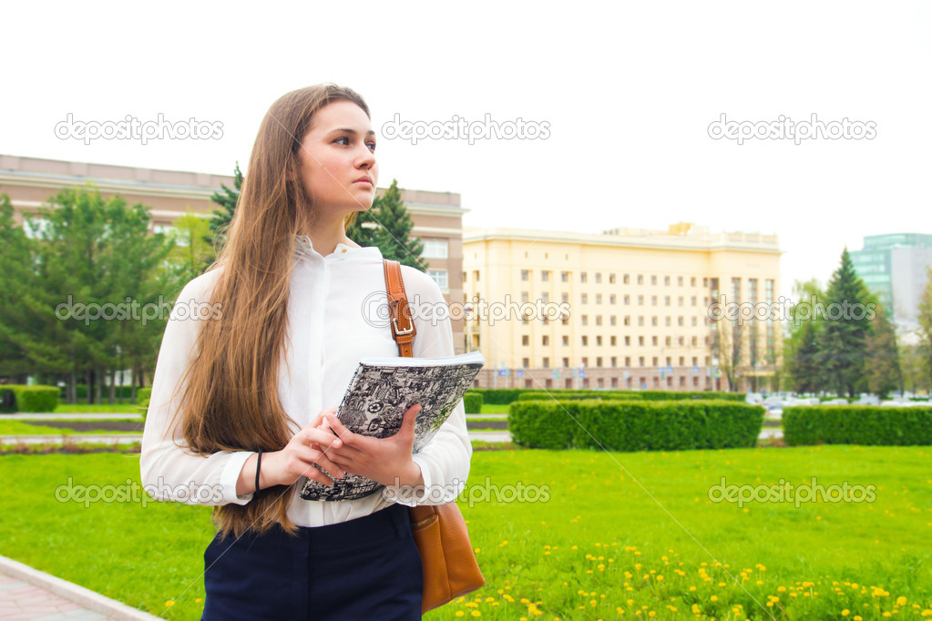 Woman with textbook outdoor