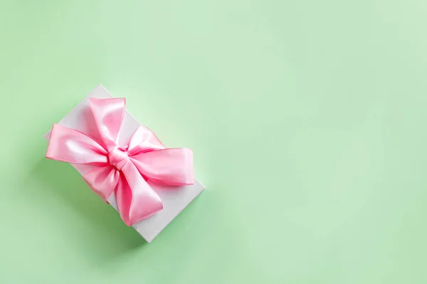 礼品盒 带粉色丝带 绿色彩绘背景 顶视图 复制空间 庆祝母亲节或生日的概念 — 图库照片
