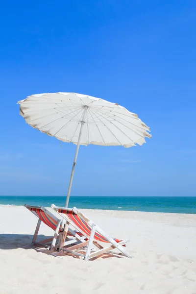 Colorful wooden beach chairs with sun umbrella — Stock Photo, Image