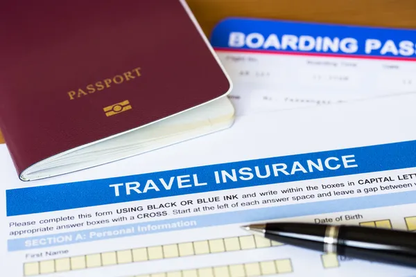 Travel insurance application form with pen and passport — Stock Photo, Image