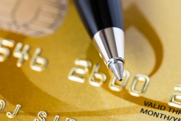 Pen on gold credit card — Stock Photo, Image