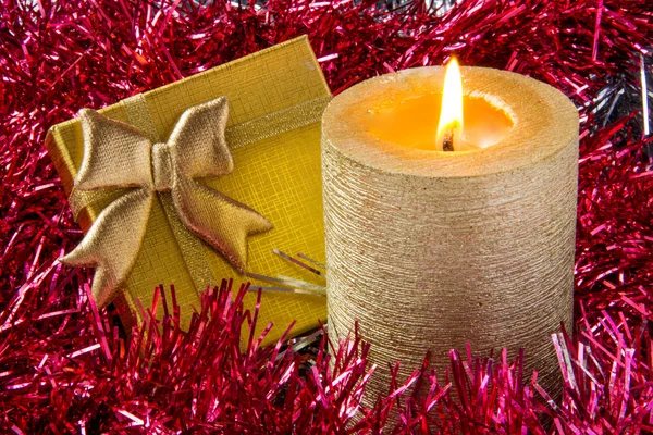 Gold candle with gift — Stock Photo, Image