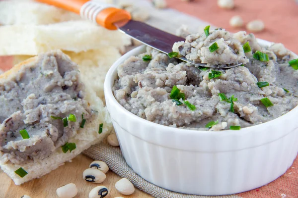 Fresh pate of white haricot in ceramic cup and on toast — Stock Photo, Image