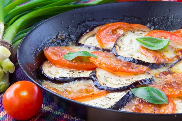 Roasted tomatoes, eggplant and cheese on pan with basil — Stock Photo, Image