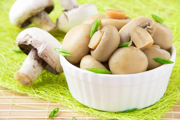 Conserved mushrooms in a white ceramic cup — Stock Photo, Image