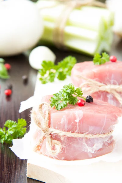 Fresh fillet of raw meat with spices and herbs on a wooden backg — Stock Photo, Image