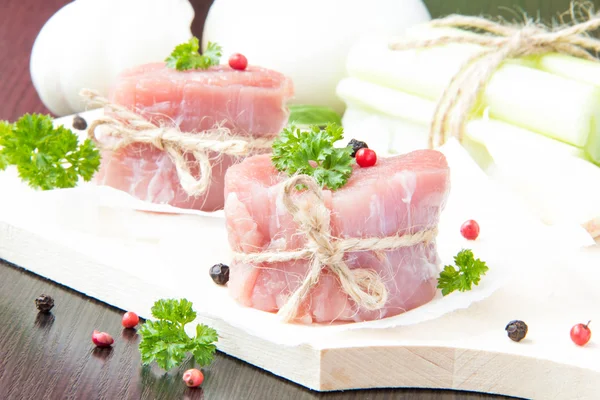 Fresh fillet of raw meat tied with twine on wooden desk with pep — Stock Photo, Image
