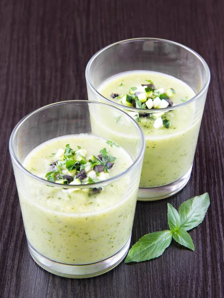 Vegetable cream soup with avocado, herbs, zucchini and black oli — Stock Photo, Image