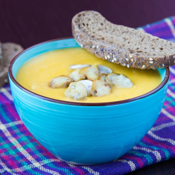 Delicious orange cream soup with mushrooms champignon and bread — Stock Photo, Image