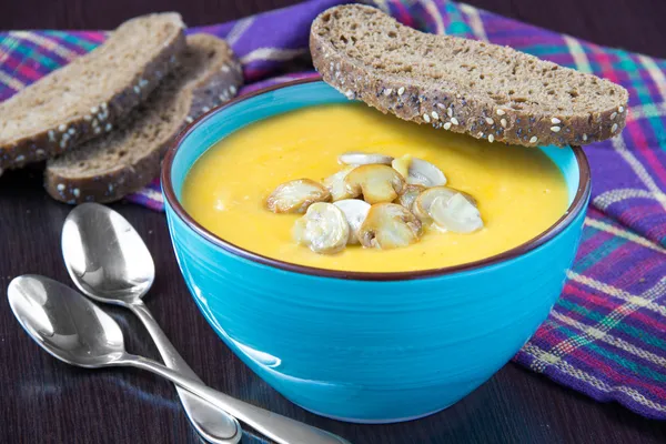 Delicious orange cream soup with mushrooms champignon and bread — Stock Photo, Image