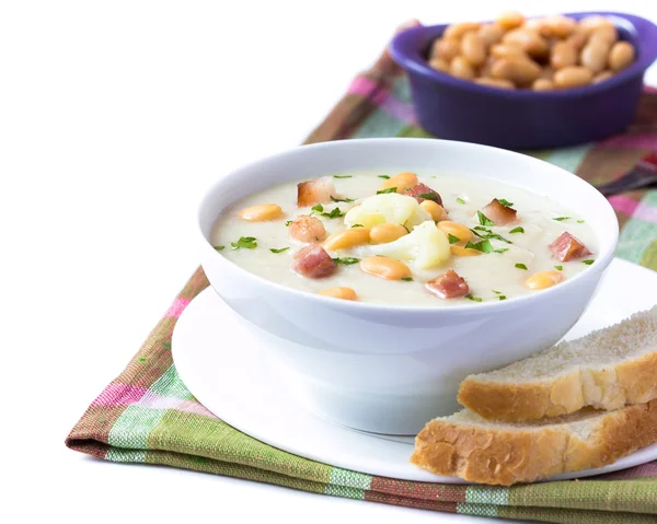 Cream soup with cauliflower, white beans and fried bacon in whit — Stock Photo, Image