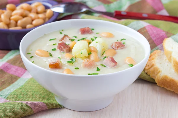Sahnesuppe mit Blumenkohl, weißen Bohnen und gebratenem Speck — Stockfoto
