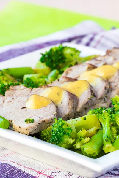Baked, sliced fillet of pork with green vegetables, broccoli and — Stock Photo, Image