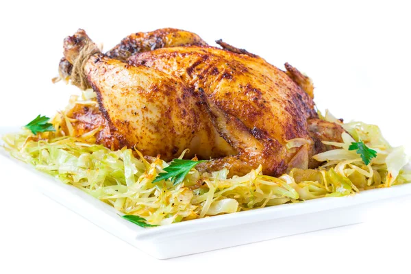 Roasted whole chicken with golden crust and garnish of stewed ca — Stock Photo, Image