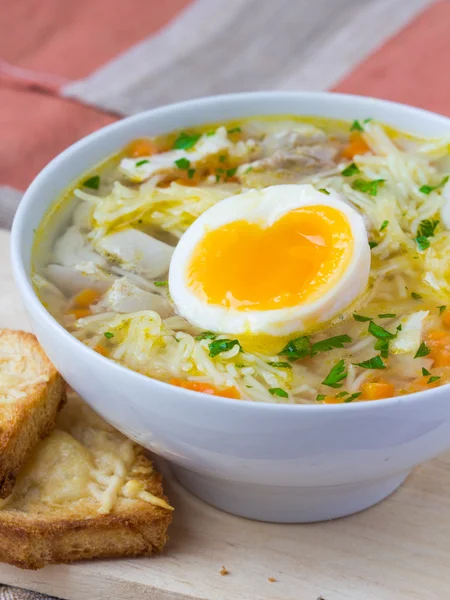 Chicken soup with noodles, carrots and cheese croutons — Stock Photo, Image