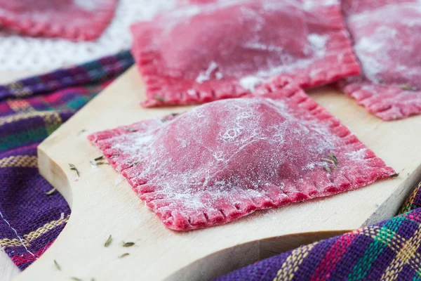 Homemade raw pink pasta ravioli with beet fillings — Stock Photo, Image