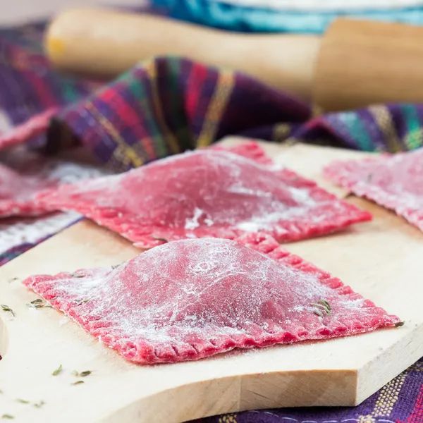 Homemade raw pink pasta ravioli with beet fillings — Stock Photo, Image