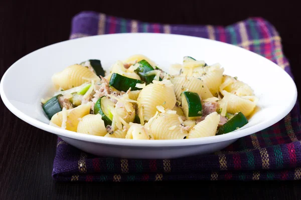 Pasta with tuna, zucchini, sauce and herbs on plate, delicious d — Stock Photo, Image
