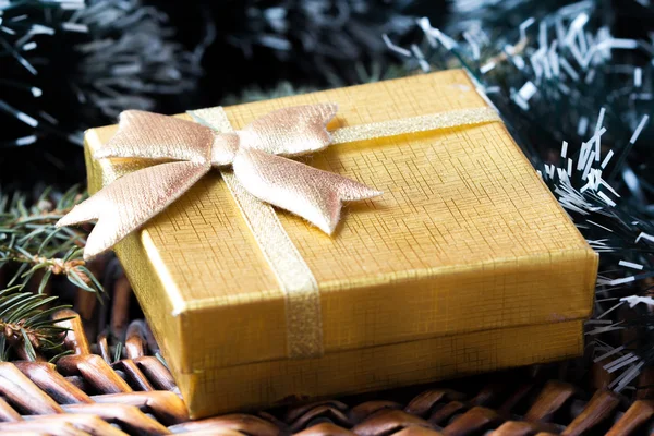 Gift in gold box under tree for Christmas — Stock Photo, Image