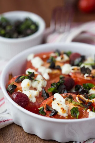 Tomatoes baked with cheese feta, smoked sausages, herbs, olives, — Stock Photo, Image