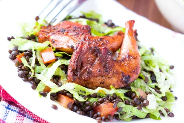 Delicious salad with black lentils, fried legs quail, tomatoes, — Stock Photo, Image