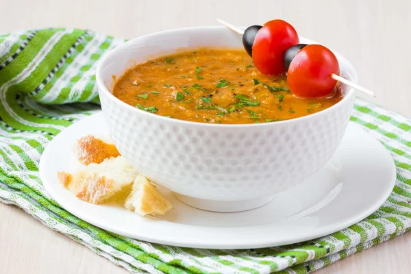 Vegetable soup in bowl with olives, starter, tasty appetizer for guests — Stock Photo, Image
