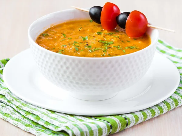 Vegetable soup in bowl with olives, starter, tasty appetizer for guests — Stock Photo, Image