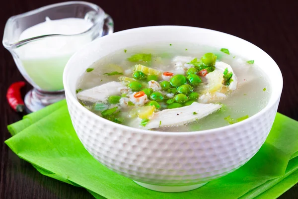 Chicken soup with green peas, pearl barley, chili pepper, food — Stock Photo, Image