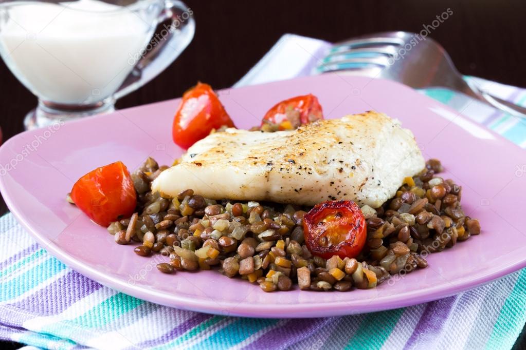 White fish fillet of perch, cod with vegetables and lentils, tom