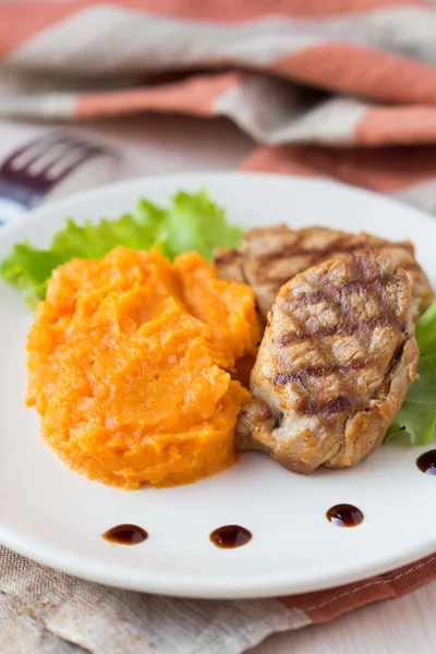 Pork steak fried on grill with mashed sweet potatoes, tasty — Stock Photo, Image