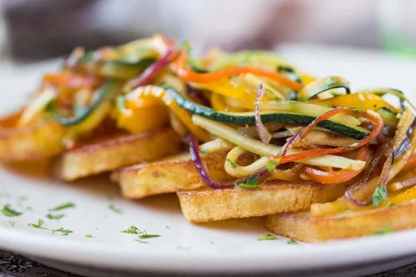 Gebakken plakjes aardappel met fijngehakte stokken groenten, le — Stockfoto