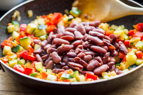 Cooking stew ratatouille from vegetables with beans in frying pa — Stock Photo, Image