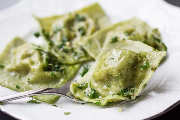 Ravioli pasta from green dough with mushroom stuffing, oil, pars — Stock Photo, Image