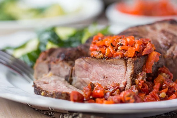 Grilled beef steak with salsa sauce dried tomatoes, red peppers — Stock Photo, Image